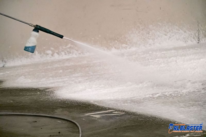 Technician is doing Easypark underground parking lot pressure washing.