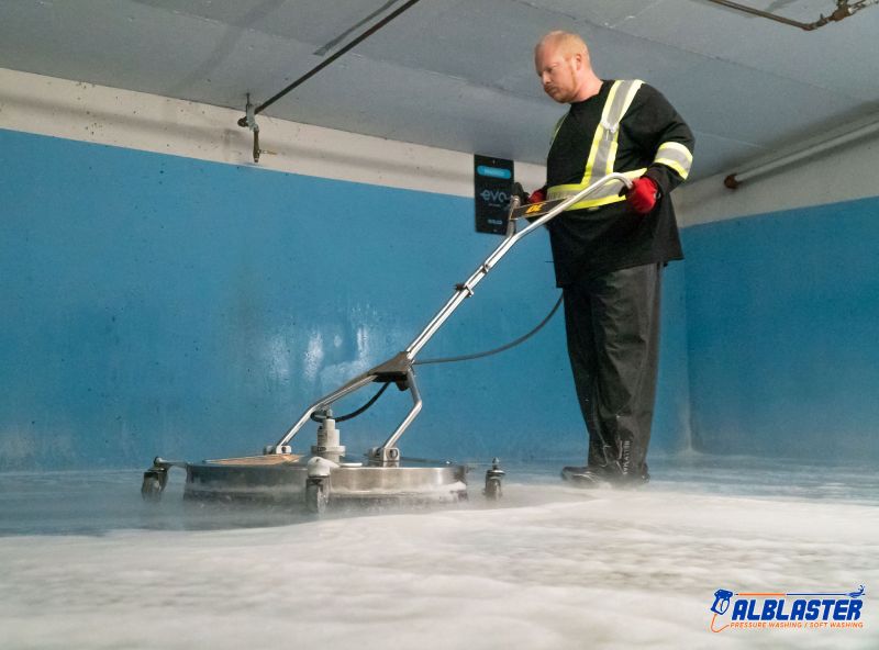 Technician is doing Easypark underground parking lot pressure washing.