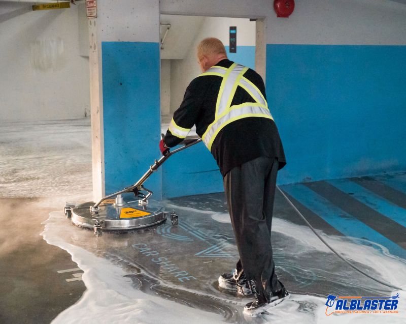 Technician is doing Easypark underground parking lot (ground) pressure washing.
