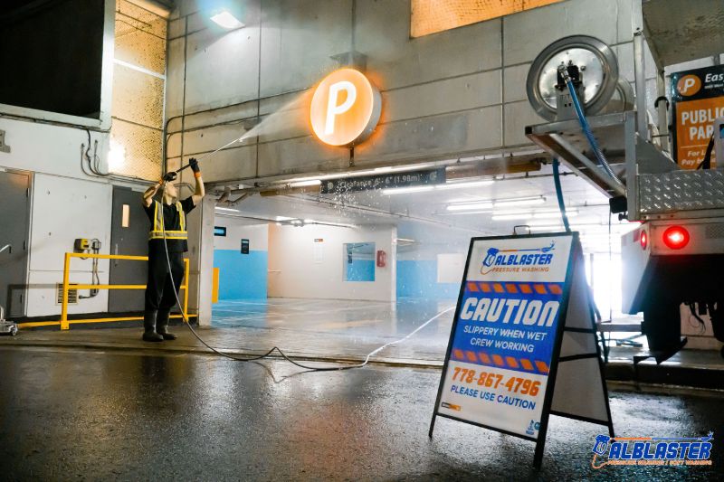 Technician is doing Easypark underground parking lot (entrance) pressure washing.