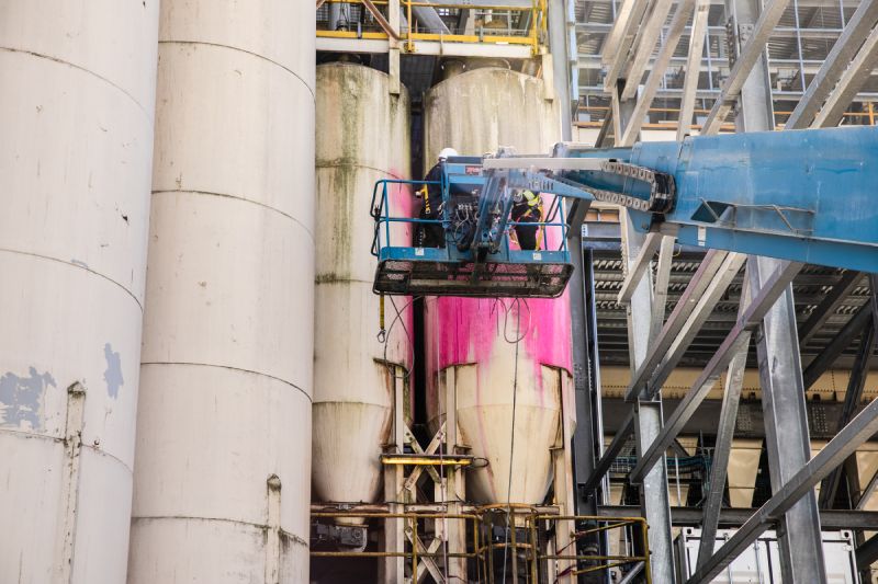 Technician is performing Industrial pressure washing silos service 2