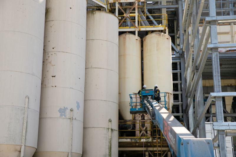 Technician is performing Industrial pressure washing silos service 4