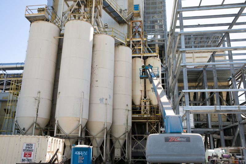 Technician is performing Industrial pressure washing silos service 5