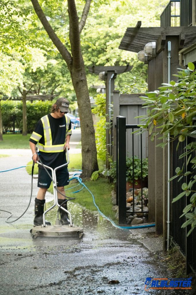 Our crew member cleaning a sidewalk with pressure washing