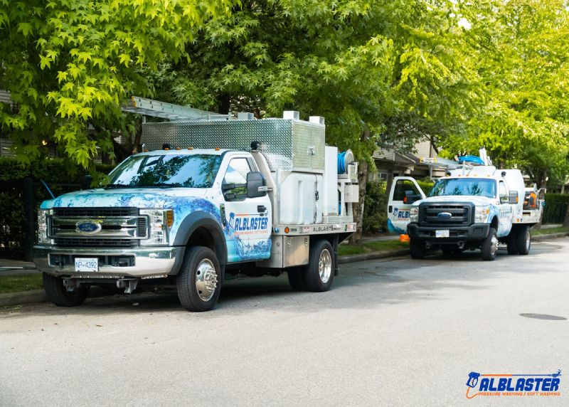 Alblaster pressure washing trucks in action.