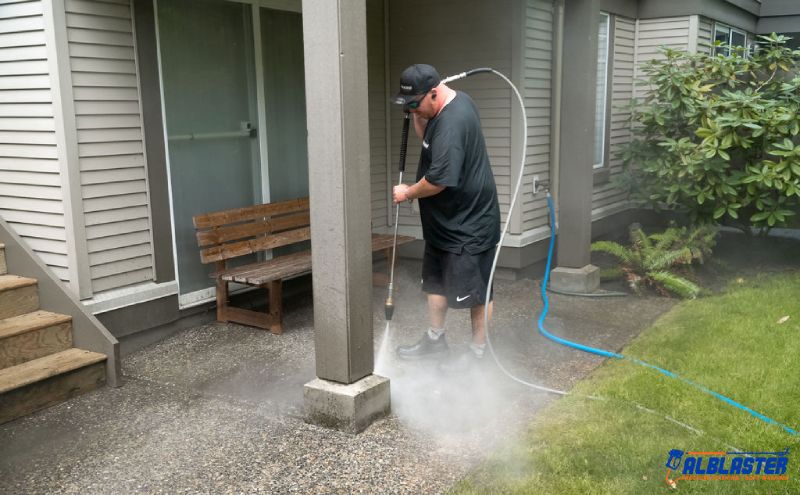 Pressure washing crew member on the back terrace