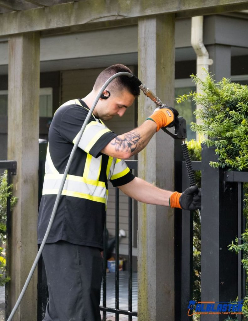 Alblaster crew pressure washing strata building.